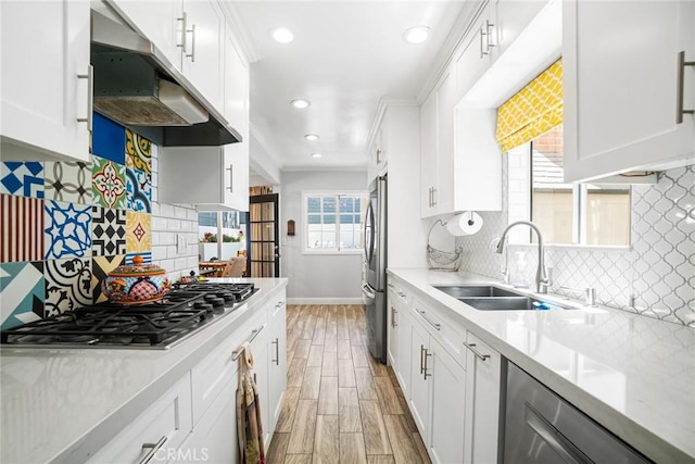 1742 Dixon St, Redondo Beach, CA 90278 - kitchen featuring under cabinet range hood, appliances with stainless steel finishes, light wood-style flooring, baseboards, and light countertops