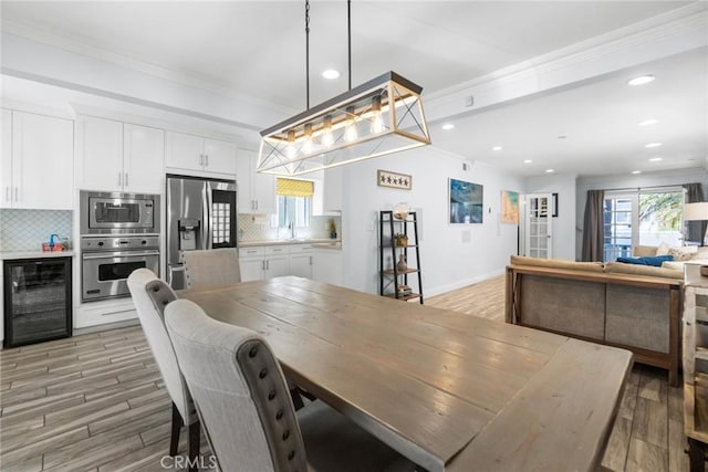 1742 Dixon St, Redondo Beach, CA 90278 - dining room featuring beverage cooler, recessed lighting, ornamental molding, light wood-style flooring, and baseboards