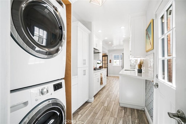 1742 Dixon St, Redondo Beach, CA 90278 - laundry room featuring stacked washer and clothes dryer, light wood-style flooring, baseboards, and recessed lighting