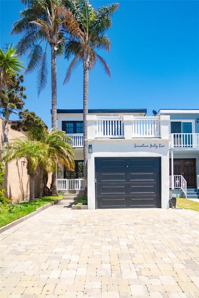 1742 Dixon St, Redondo Beach, CA 90278 - beach home with decorative driveway, stucco siding, a balcony, and a garage