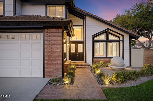 800 Coronado Pl, Oxnard, CA 93030 - property entrance with an attached garage, brick siding, and french doors