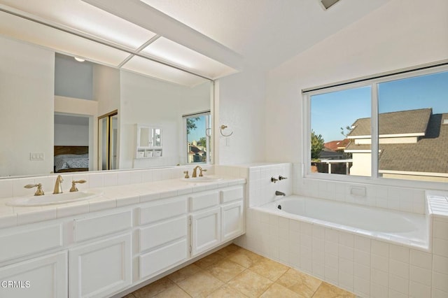 800 Coronado Pl, Oxnard, CA 93030 - full bathroom featuring double vanity, ensuite bath, a garden tub, lofted ceiling, and tile patterned flooring