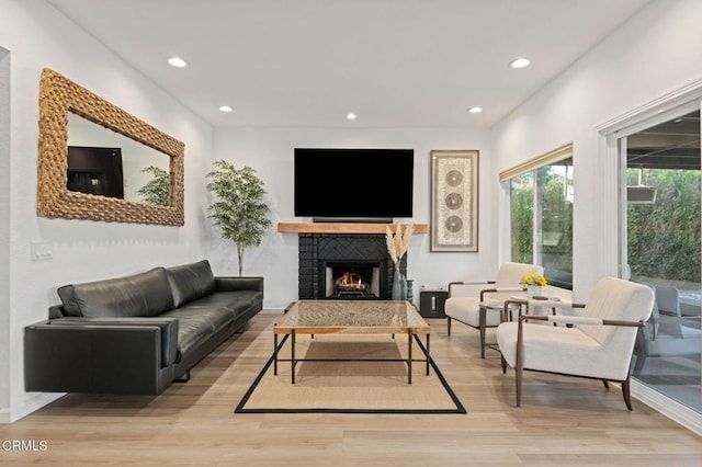 800 Coronado Pl, Oxnard, CA 93030 - living area with light wood-style floors, recessed lighting, a warm lit fireplace, and baseboards