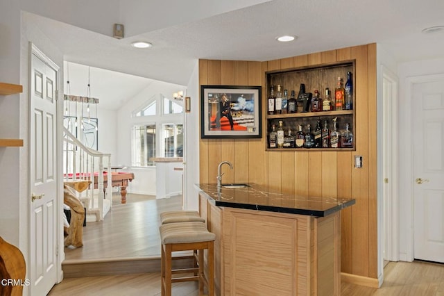 800 Coronado Pl, Oxnard, CA 93030 - indoor wet bar featuring a chandelier, light wood-type flooring, wooden walls, recessed lighting, and baseboards