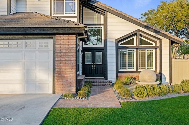 800 Coronado Pl, Oxnard, CA 93030 - view of front of house featuring concrete driveway, a garage, brick siding, fence, and french doors