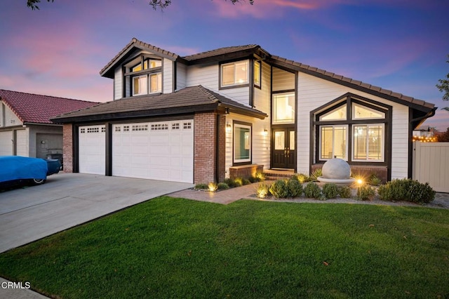 800 Coronado Pl, Oxnard, CA 93030 - view of front of house with driveway, a yard, a garage, and brick siding