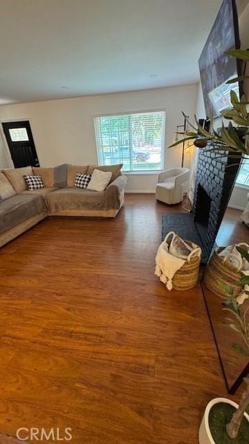 living area with wood finished floors and a fireplace