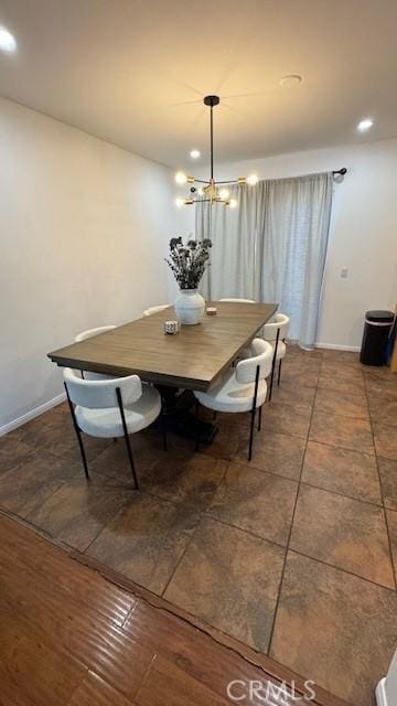 dining space featuring recessed lighting, baseboards, and a chandelier