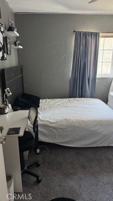 carpeted bedroom with a textured ceiling