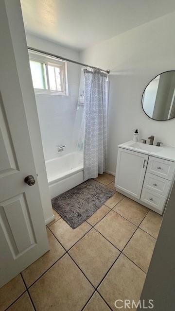 bathroom with tile patterned floors, vanity, and shower / tub combo