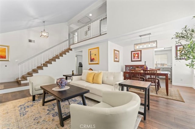 22833 Finch St, Grand Terrace, CA 92313 - living area with stairs, wood finished floors, high vaulted ceiling, and baseboards
