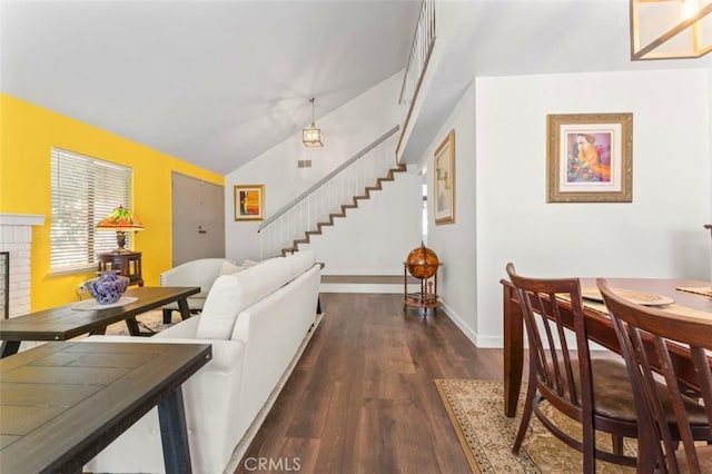 22833 Finch St, Grand Terrace, CA 92313 - dining area with stairs, wood finished floors, lofted ceiling, baseboards, and a fireplace