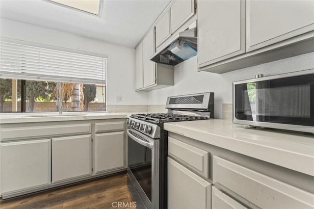22833 Finch St, Grand Terrace, CA 92313 - kitchen with appliances with stainless steel finishes, under cabinet range hood, light countertops, and a sink