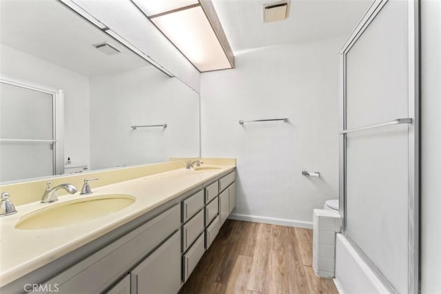 22833 Finch St, Grand Terrace, CA 92313 - full bath featuring toilet, an enclosed shower, wood finished floors, double vanity, and baseboards