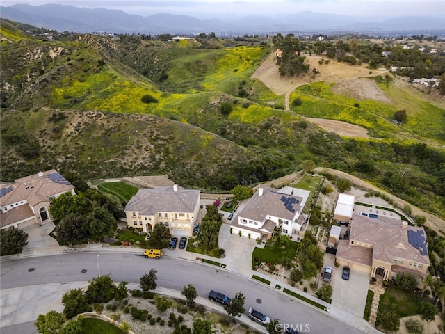 aerial overview of property's location featuring mountains and nearby suburban area
