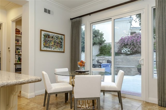 dining space with crown molding, light tile patterned floors, and baseboards