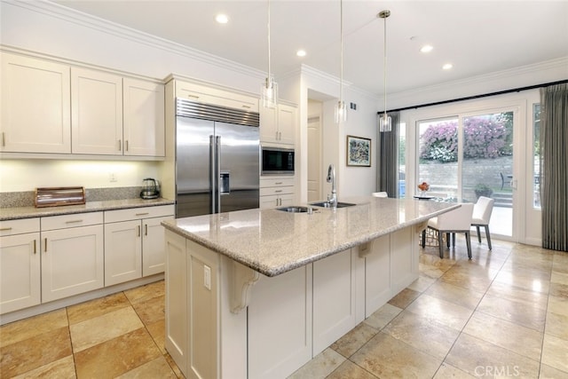 kitchen with built in appliances, a sink, hanging light fixtures, light stone counters, and ornamental molding