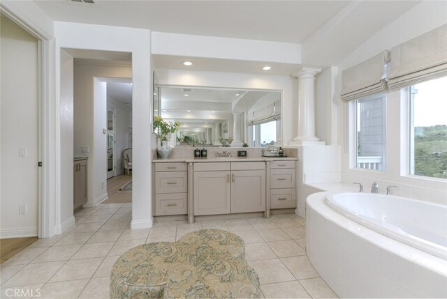 bathroom featuring plenty of natural light, a bath, vanity, recessed lighting, and tile patterned floors