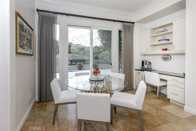 dining space with crown molding and baseboards