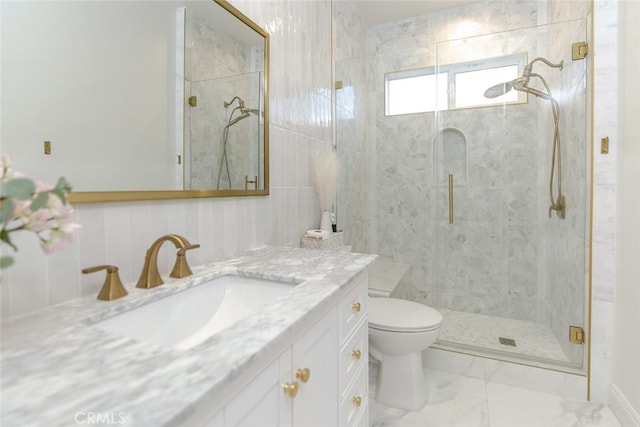 bathroom with a shower stall, vanity, and toilet