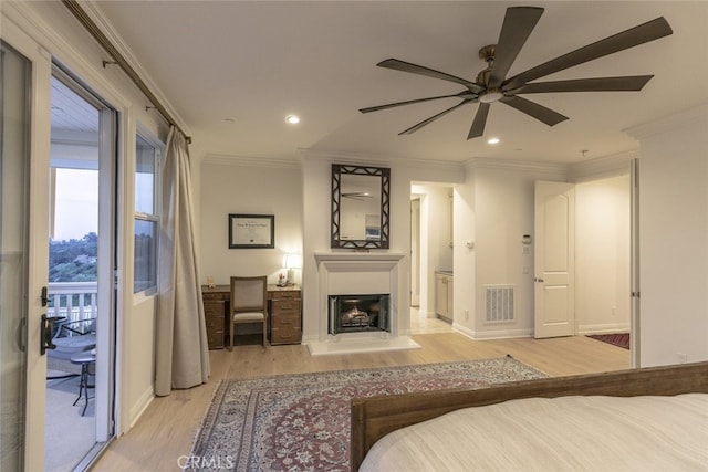 bedroom featuring light wood-style floors, access to outside, recessed lighting, ornamental molding, and a fireplace with raised hearth