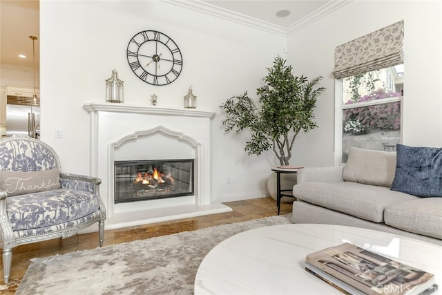living area with crown molding, a glass covered fireplace, and baseboards