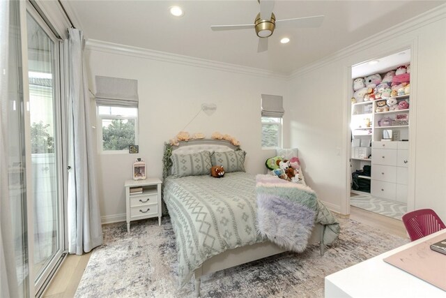 bedroom featuring wood finished floors, ornamental molding, recessed lighting, and a ceiling fan