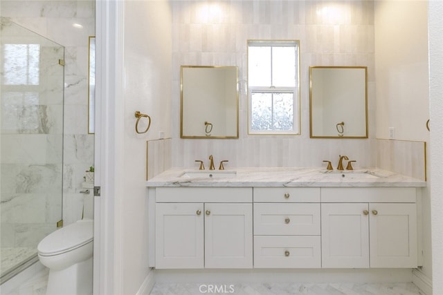 bathroom featuring a marble finish shower, toilet, double vanity, and marble finish floors