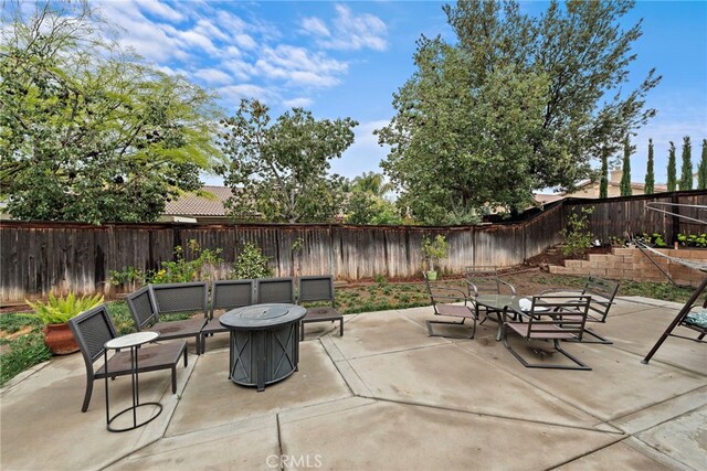 view of patio / terrace featuring a fenced backyard and an outdoor fire pit