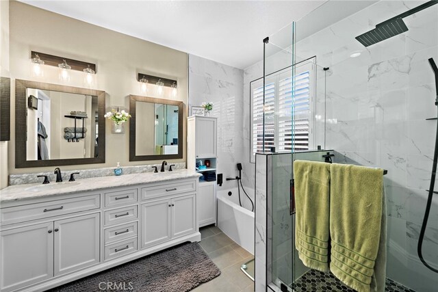 full bath featuring a marble finish shower, double vanity, a garden tub, and tile patterned floors