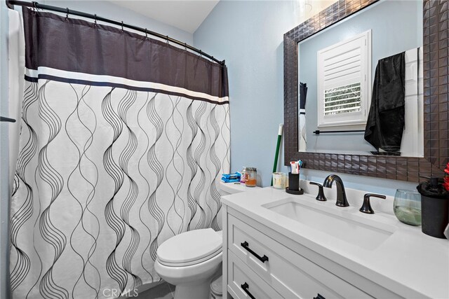 bathroom featuring toilet and vanity