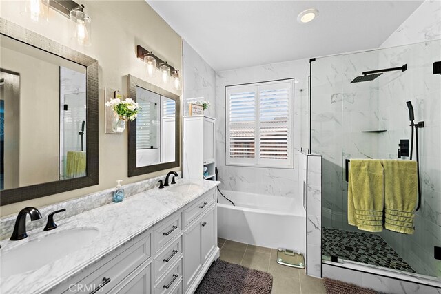 bathroom with a marble finish shower, double vanity, a garden tub, and tile patterned floors