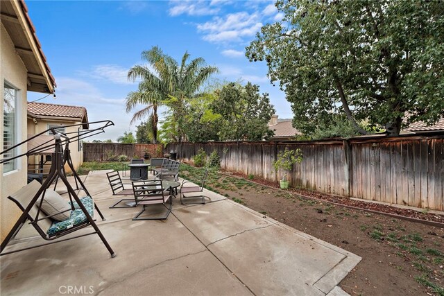 view of patio featuring outdoor dining area and a fenced backyard