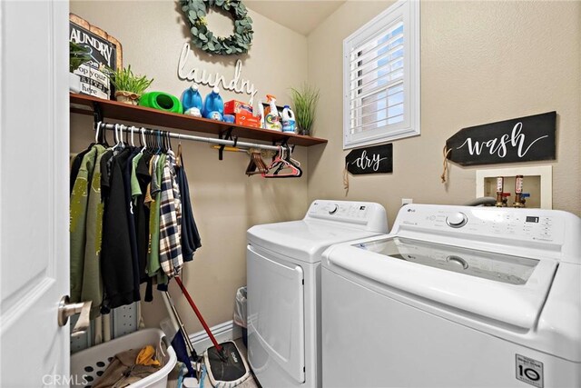 washroom featuring independent washer and dryer and baseboards