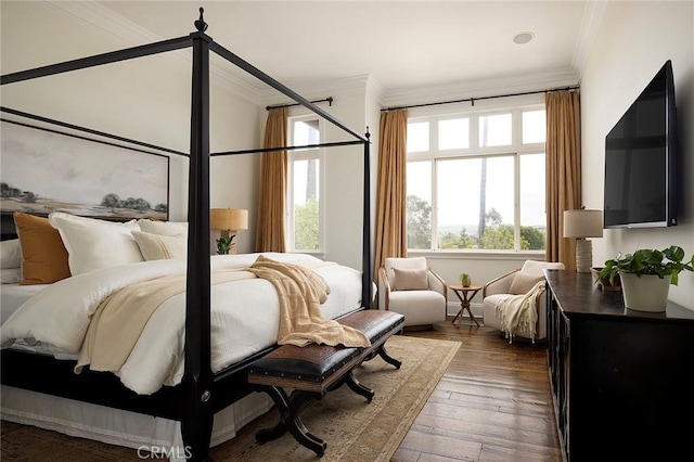bedroom with crown molding and wood-type flooring