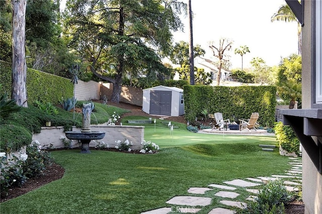 view of yard with an area to practice putting, a storage shed, and an outbuilding
