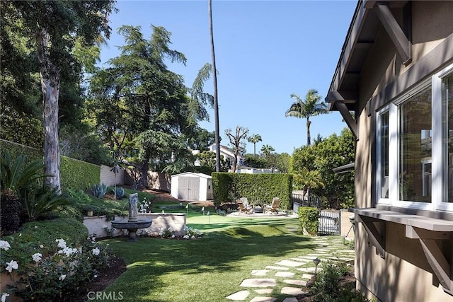 view of yard featuring a shed and an outdoor structure