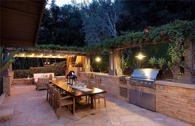 view of patio featuring area for grilling, an outdoor kitchen, and outdoor dining space