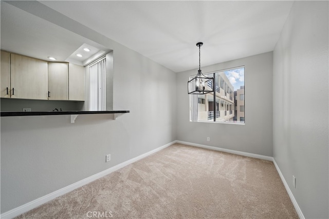7826 Topanga Canyon Blvd Unit 218, Canoga Park, CA 91304 - unfurnished dining area with light colored carpet, a chandelier, baseboards, and recessed lighting