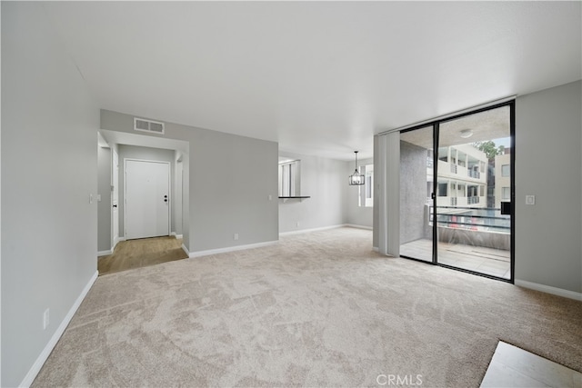 7826 Topanga Canyon Blvd Unit 218, Canoga Park, CA 91304 - unfurnished living room with carpet flooring and baseboards