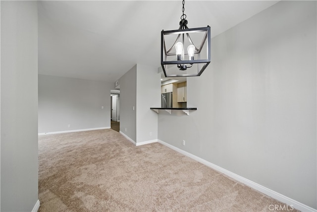 7826 Topanga Canyon Blvd Unit 218, Canoga Park, CA 91304 - unfurnished living room featuring a chandelier, carpet, and baseboards