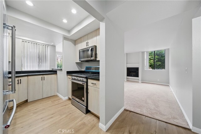7826 Topanga Canyon Blvd Unit 218, Canoga Park, CA 91304 - kitchen with stainless steel appliances, light wood-type flooring, dark countertops, baseboards, and recessed lighting