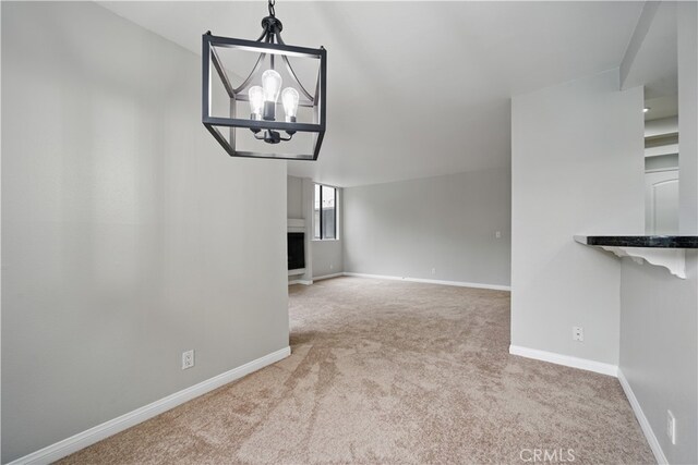 7826 Topanga Canyon Blvd Unit 218, Canoga Park, CA 91304 - unfurnished dining area featuring carpet flooring, a chandelier, and baseboards