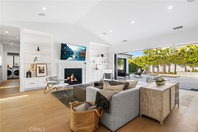 1530 Anita Ln, Newport Beach, CA 92660 - living room featuring independent washer and dryer, built in shelves, a premium fireplace, light wood-type flooring, and recessed lighting