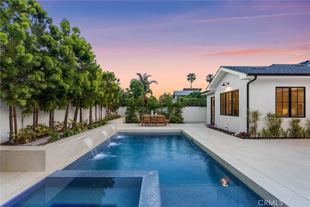 1530 Anita Ln, Newport Beach, CA 92660 - pool at dusk featuring a fenced backyard, a patio area, and a pool with connected hot tub