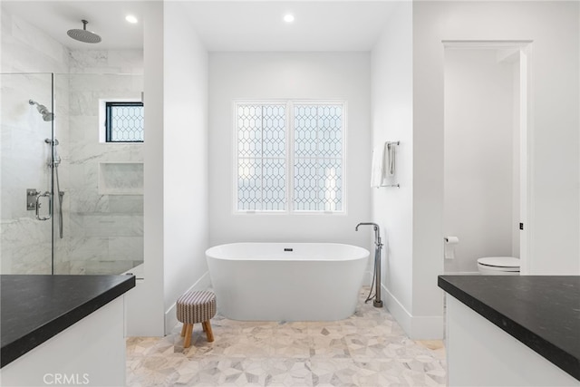 bathroom with a marble finish shower, a soaking tub, vanity, recessed lighting, and baseboards