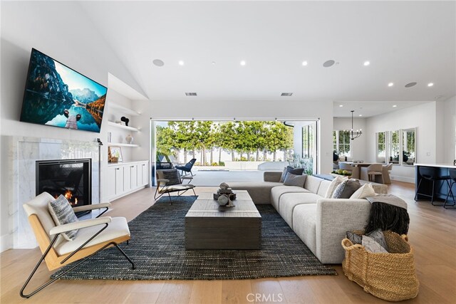 1530 Anita Ln, Newport Beach, CA 92660 - living area with built in features, wood finished floors, a fireplace, recessed lighting, and high vaulted ceiling