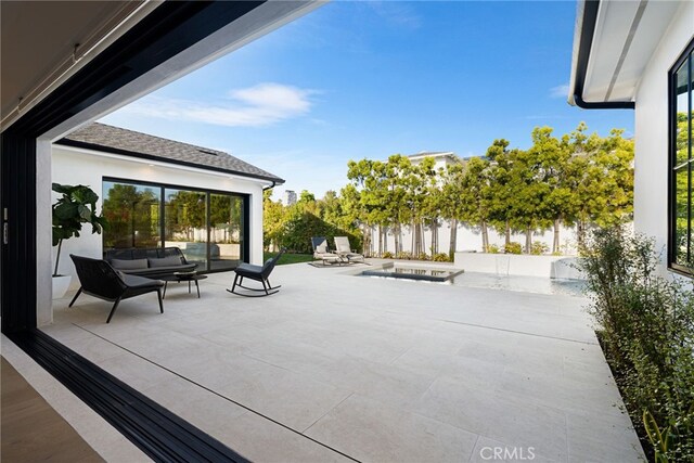 view of patio featuring an outdoor hangout area and fence