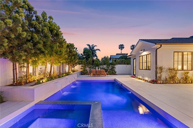 1530 Anita Ln, Newport Beach, CA 92660 - pool at dusk featuring a fenced backyard, a patio area, and a pool with connected hot tub
