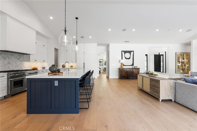 1530 Anita Ln, Newport Beach, CA 92660 - kitchen with double oven range, open floor plan, white cabinetry, decorative backsplash, and light wood-type flooring